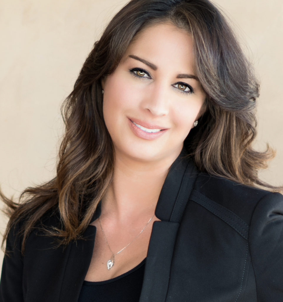 A woman in black jacket smiling for the camera.