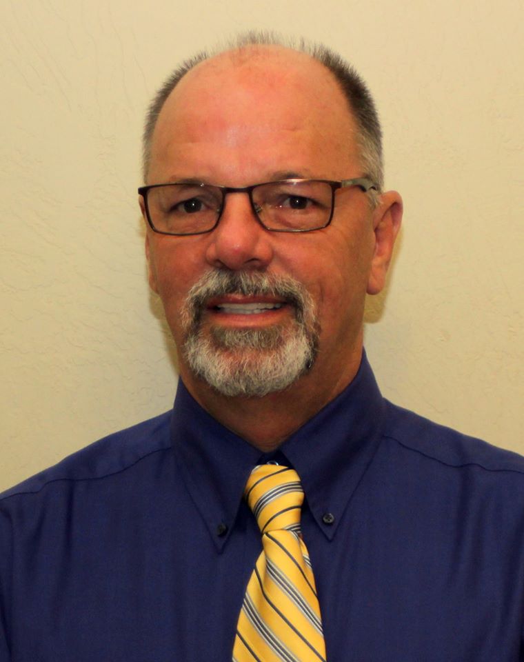 A man with glasses and a blue shirt